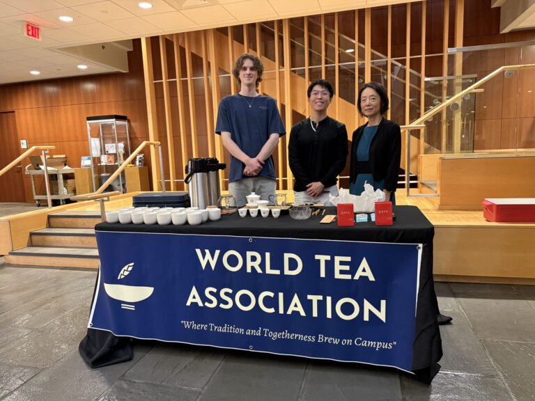 Jarrah, Will, and Zhou Laoshi standing behind a Gongfu Tea Table